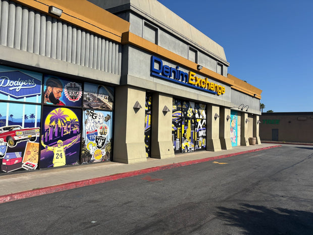 Denim Exchange storefront with colorful window graphics and signage
