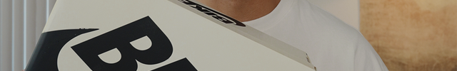 Person holding a Nike SB "Bike" shoebox in a bright indoor setting