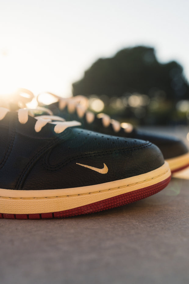 Nike Dunk low black leather sneaker close-up with sunset lighting