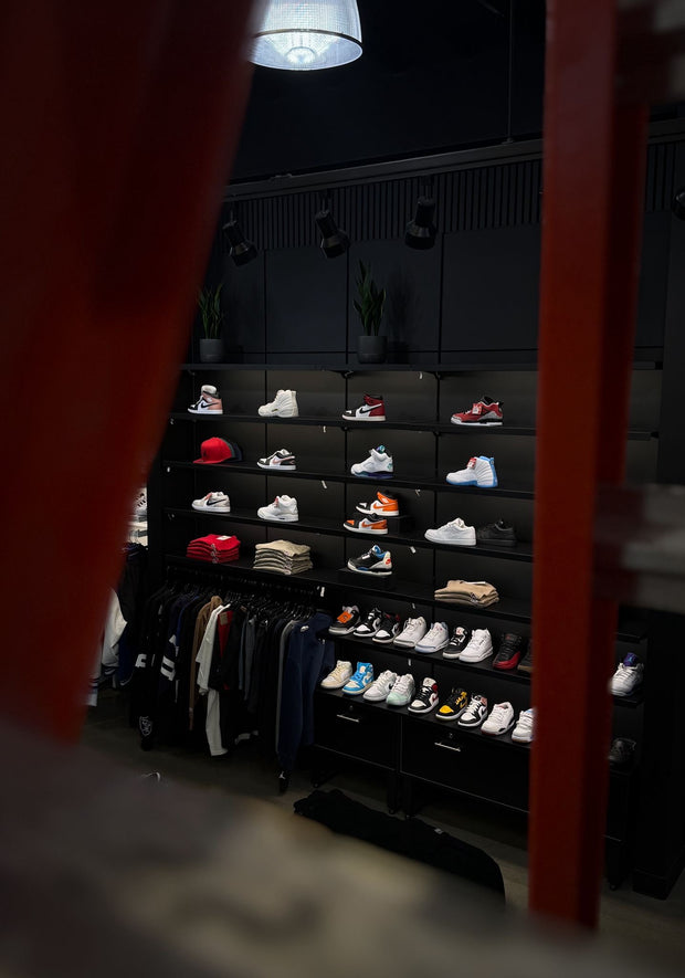 Sneaker wall display with colorful shoes and streetwear racks in store