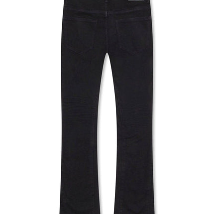Back view of black denim Valabasas Mr. Stacked jeans featuring a slim fit, belt loops, and branded leather patch.