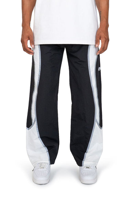 EPTM Cloud nylon joggers in black with wide white curved side panels, loose fit, and elastic cuffs on white sneakers.