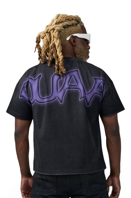 Back view of a black cotton Duaa Creature T-shirt featuring a large, stylized purple graphic across the upper back.