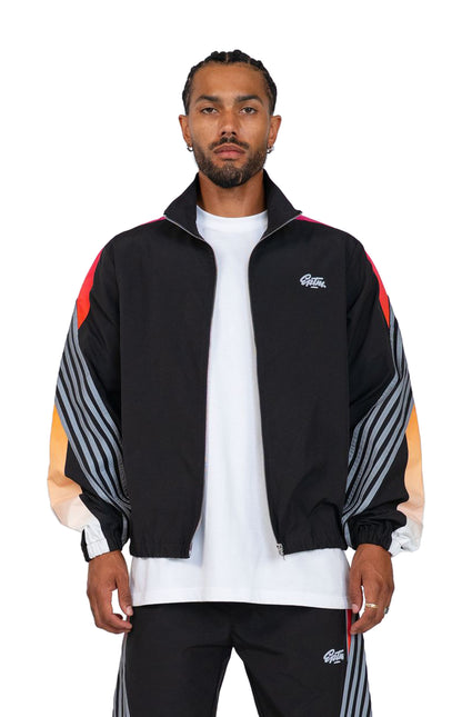 EPTM Proxy track jacket in black featuring a vibrant red-to-orange gradient and grey pinstripe sleeves on a model.