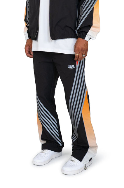 EPTM Proxy pants in black with white logo, featuring grey diagonal stripes and an orange gradient side panel finish.