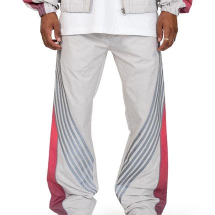 EPTM Proxy track pants in grey featuring a relaxed nylon fit with diagonal reflective stripes and red side panels.