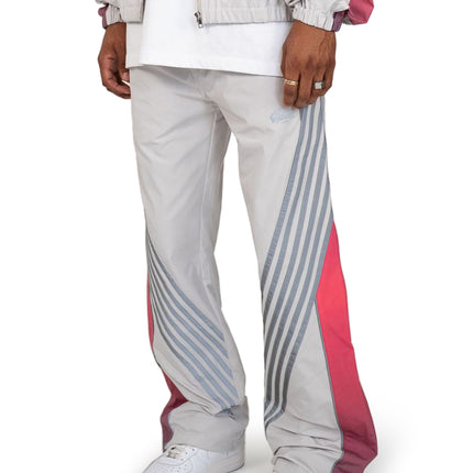 EPTM Proxy pants in grey feature a lightweight nylon finish with diagonal grey stripes and bold pink side panels.