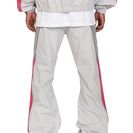 EPTM Proxy pants in grey featuring a lightweight nylon finish with vertical pink piping and grey side stripe details.