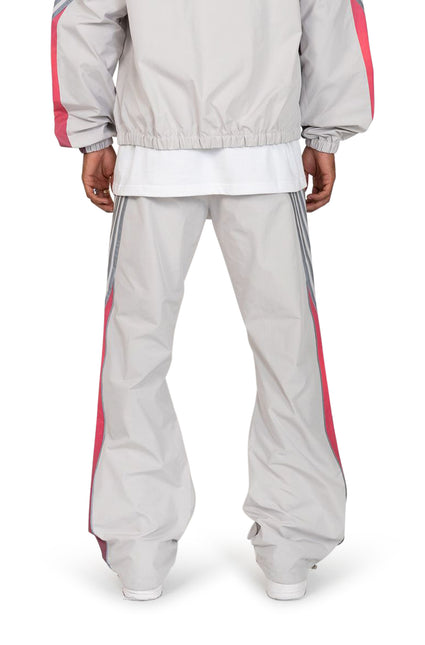 EPTM Proxy pants in grey featuring a lightweight nylon finish with vertical pink piping and grey side stripe details.