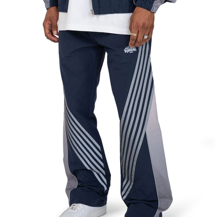 EPTM Proxy pants in navy featuring a loose fit, matte nylon finish, and distinctive grey diagonal stripe detailing.