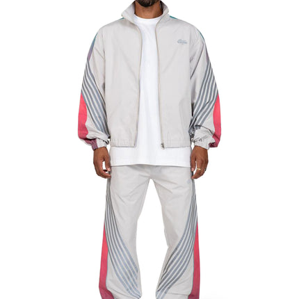 EPTM Proxy grey nylon tracksuit featuring a zip-up track jacket and matching pants with teal and pink striped side panels.