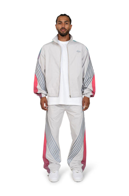 EPTM Proxy grey nylon tracksuit featuring a zip-up track jacket and matching pants with teal and pink striped side panels.