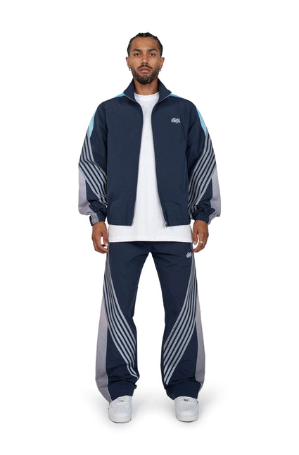 EPTM Navy Proxy jacket and matching track pants featuring a distinct blue stripe detail and sporty nylon finish.