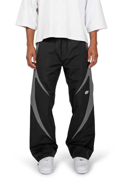 EPTM Blade pants in black featuring a smooth nylon finish with contrasting grey curved side panels and a tapered fit.