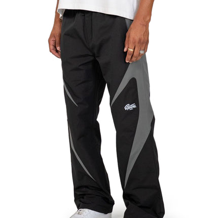 EPTM Blade pants in black with grey paneling detail, featuring a technical nylon construction and a relaxed, straight fit.