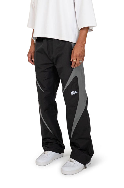 EPTM Blade pants in black with grey paneling detail, featuring a technical nylon construction and a relaxed, straight fit.