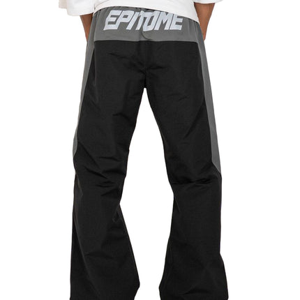 EPTM Blade pants in black and grey technical fabric, featuring an elasticized waistband with bold white text branding.