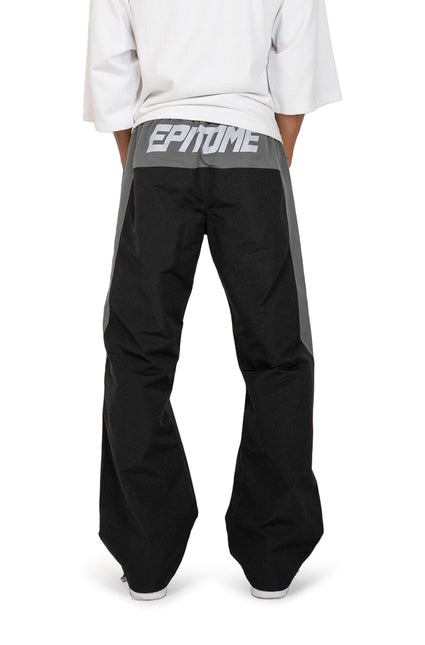 EPTM Blade pants in black and grey technical fabric, featuring an elasticized waistband with bold white text branding.