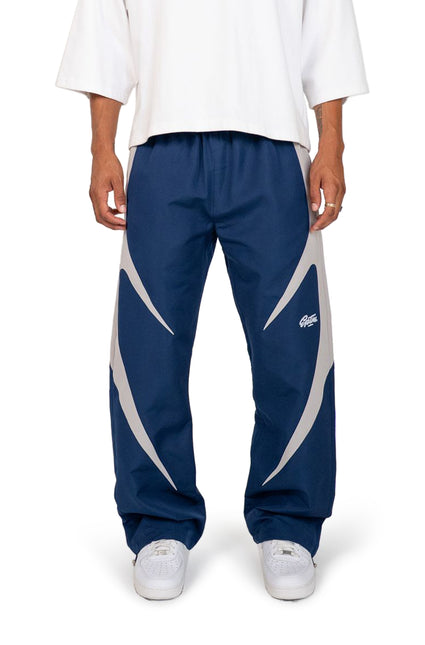 EPTM Blade pants in navy blue with grey side blade panels, featuring a relaxed nylon fit and white logo embroidery.