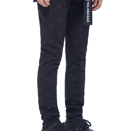 Valabasas Caelune black skinny denim jeans featuring an all-over tonal triangular logo print and hanging fabric tag.