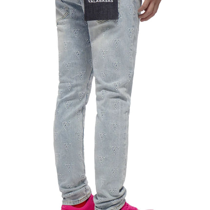 Light blue Valabasas Caelune jeans featuring an all-over white embroidered triangle logo pattern and a black back tag.