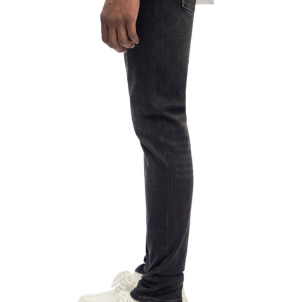 Side profile of Trnchs Monarch skinny fit jeans in jet black denim with a soft washed finish and classic hem.