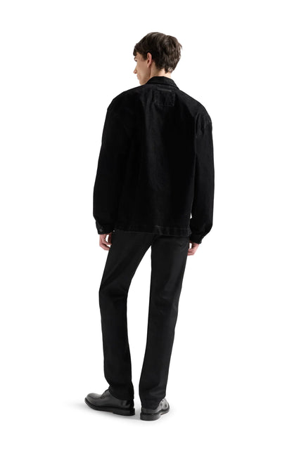 Back view of a person wearing 7 For All Mankind straight-leg jeans in a solid black denim wash on a white background.