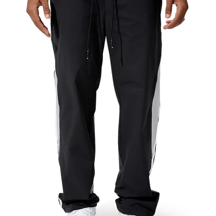 Jordan Craig black track pants featuring white side stripes, an elastic drawstring waistband, and a smooth nylon finish.