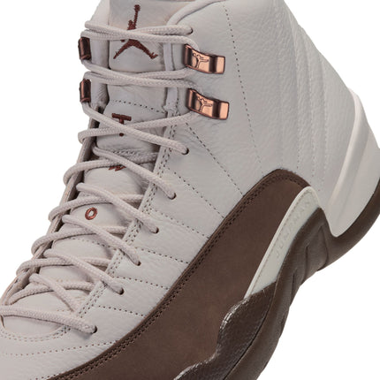 Close-up of an Air Jordan 12 Retro in light orewood brown textured leather with cocoa brown accents and metallic eyelets.