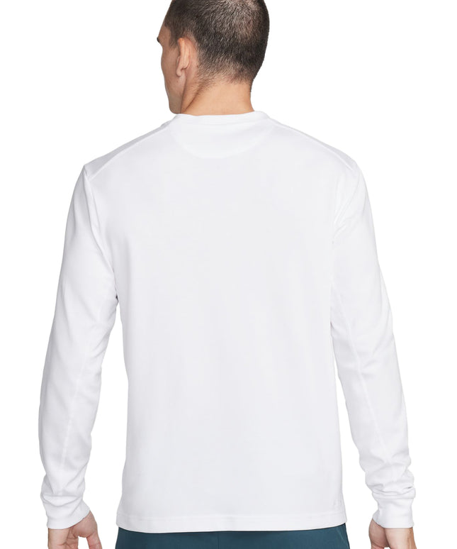 Back view of a man wearing a plain white long-sleeve t-shirt and teal shorts.