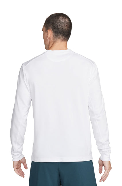 Back view of a man wearing a plain white long-sleeve t-shirt and teal shorts.