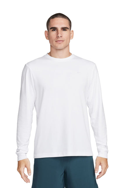 Front view of a man wearing a plain white long-sleeve t-shirt and teal shorts.
