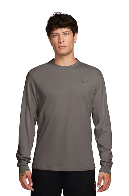 Nike Mens Primary long-sleeve athletic top in cave stone gray featuring a small black swoosh logo on the left chest.