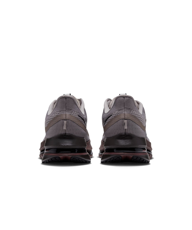 Back view of Nike Pegasus Premium sneakers in college grey mesh with dark brown midsole and black heel detailing.