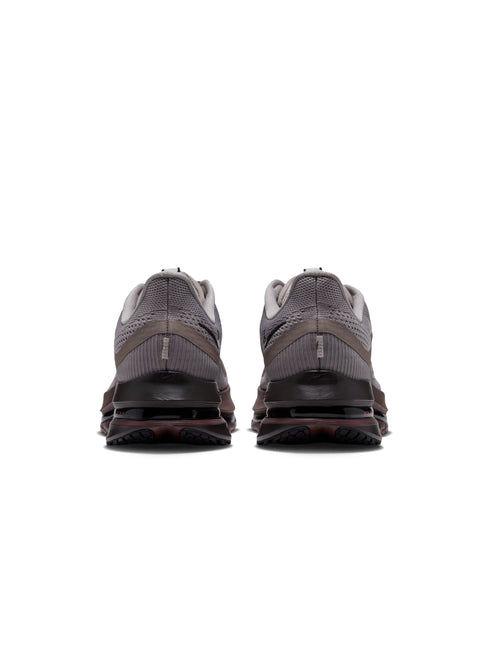Back view of Nike Pegasus Premium sneakers in college grey mesh with dark brown midsole and black heel detailing.