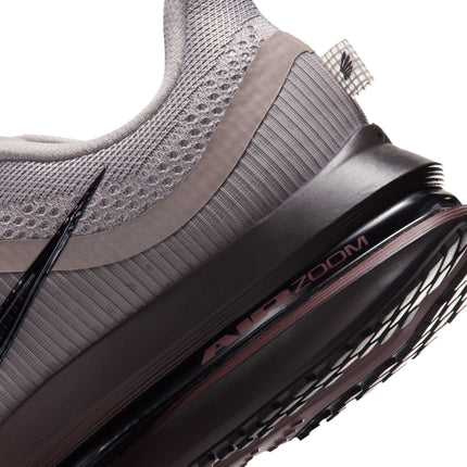 Close-up of a college grey Nike Pegasus Premium sneaker featuring a black Air Zoom midsole and a ribbed mesh heel.