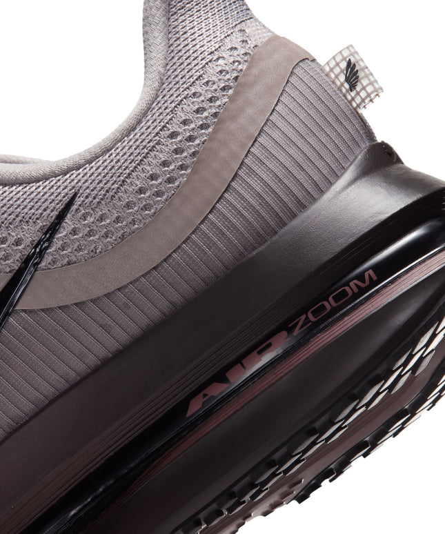 Close-up of a college grey Nike Pegasus Premium sneaker featuring a black Air Zoom midsole and a ribbed mesh heel.