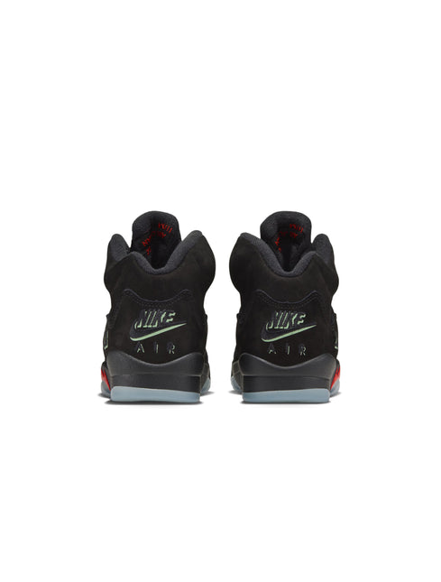 Rear view of a pair of black Air Jordan 5 sneakers showing the heel tabs with red accents.