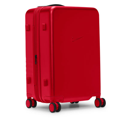 Nike carry-on luggage in university red with a hard-shell matte finish, featuring a sleek Nike swoosh and black wheels.