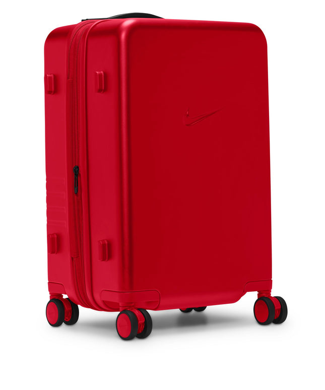 Nike carry-on luggage in university red with a hard-shell matte finish, featuring a sleek Nike swoosh and black wheels.