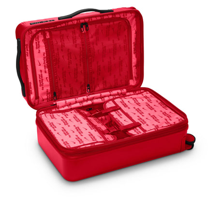 Nike carry-on luggage in university red with black trim, featuring an open interior lined with branded Nike Air fabric.