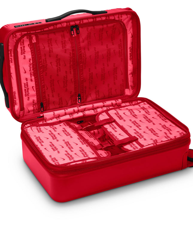 Nike carry-on luggage in university red with black trim, featuring an open interior lined with branded Nike Air fabric.