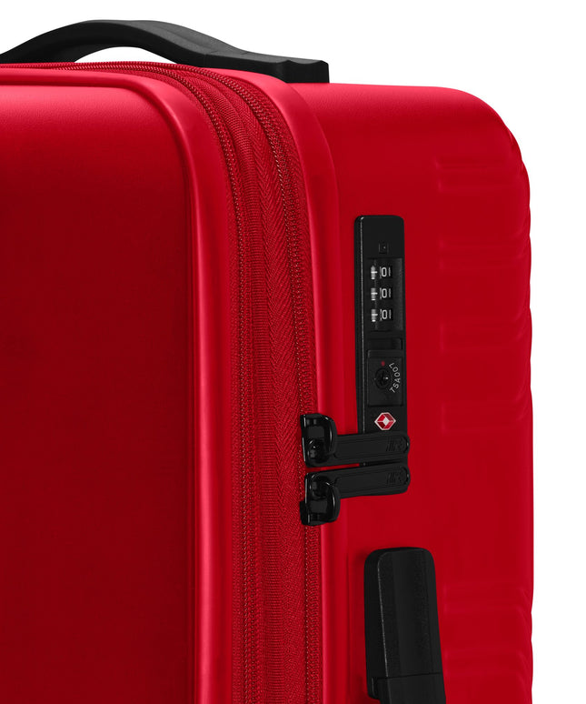 University Red hard-shell Nike carry-on luggage with a black top handle, dual-zipper closure, and TSA-approved lock.