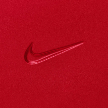 Embossed Nike swoosh logo on a vibrant university red carry-on luggage shell with a smooth, matte textured finish.