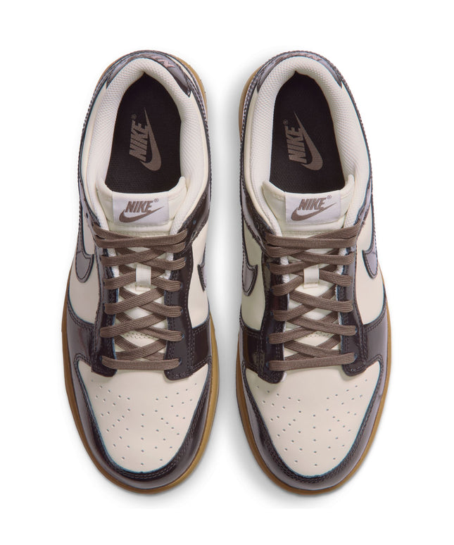Top-down view of Nike Dunk Low Retro sneakers featuring coconut milk leather uppers and glossy shadow brown overlays.
