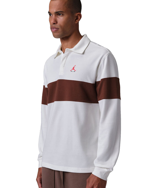 Nike Jordan Brooklyn long-sleeve polo in off-white sail with a wide bronze eclipse chest stripe and red logo detail.
