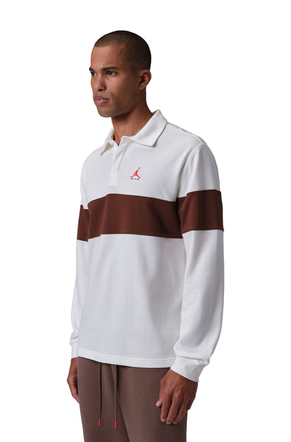 Nike Jordan Brooklyn long-sleeve polo in off-white sail with a wide bronze eclipse chest stripe and red logo detail.