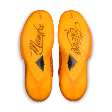 Bottom view of Nike Kobe Protro 3 sneakers in safety orange with Mamba and Forever script on translucent rubber soles.