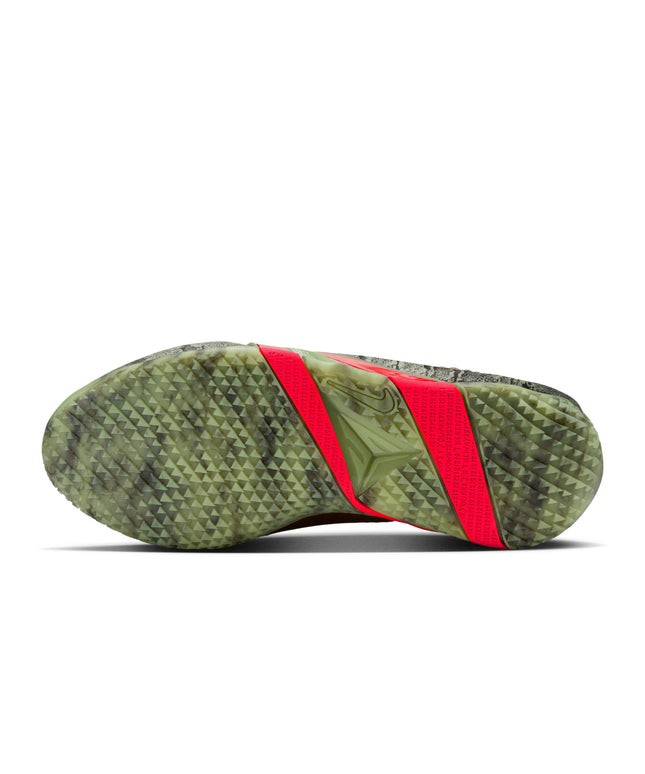 Bottom view of Nike Ja 4 Halloween sneaker featuring a textured oil green camo tread and bright red neon midfoot shank.