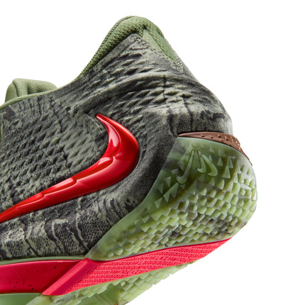 Close-up of Nike Ja 4 Halloween sneaker heel in oil green textured material with a glossy red swoosh and neon base.